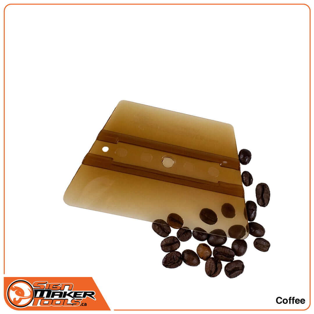 Brown SmellGood ProWrap Coffee squeegee surrounded by fresh coffee beans
