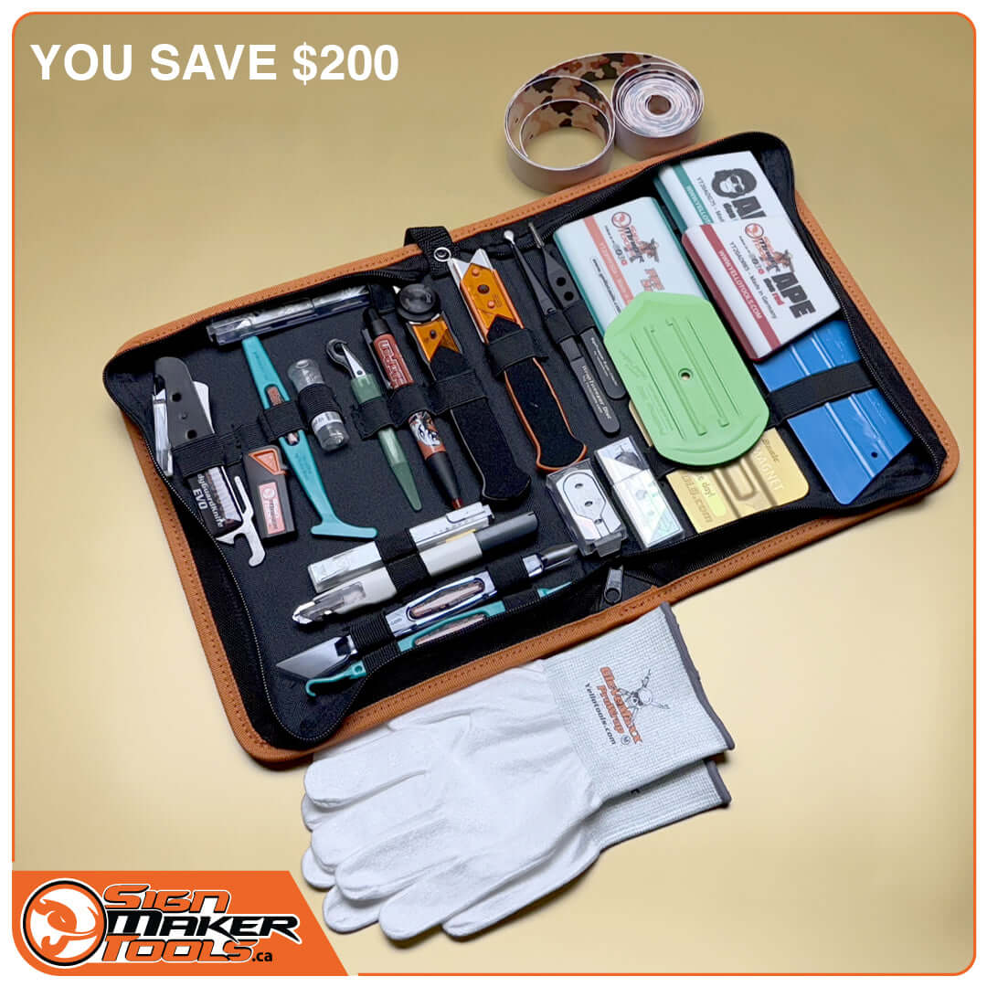 Open wrap and tint toolset case with 26 professional vinyl tools, gloves, and accessories displayed on a gold surface