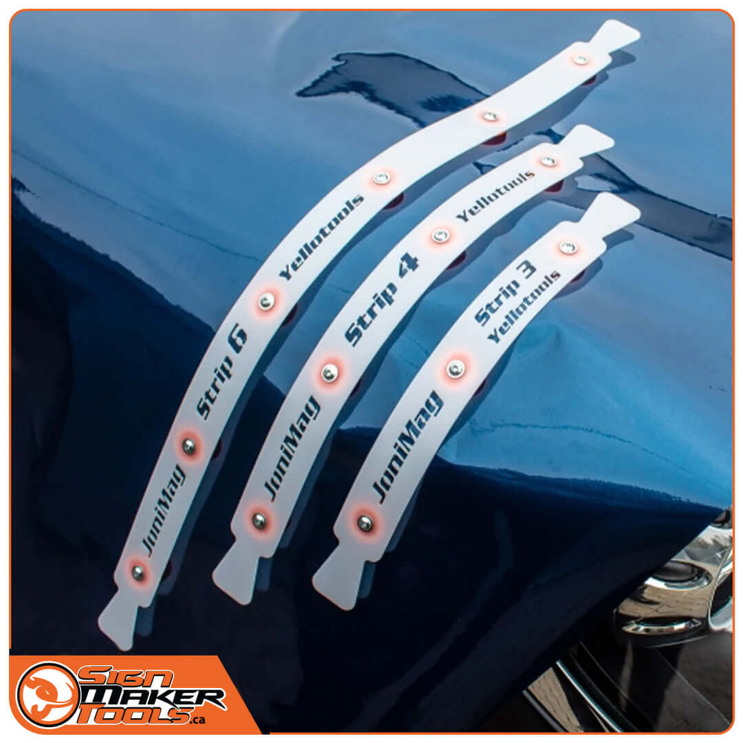 Three JoniMag flexible magnetic strips adhering securely to a curved car hood