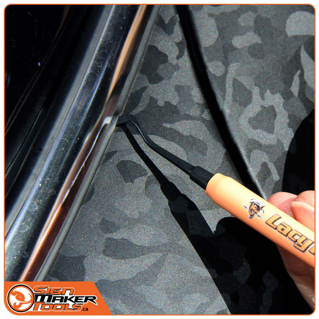 LacyTip tool applying vinyl in tight car trim areas for precise installation