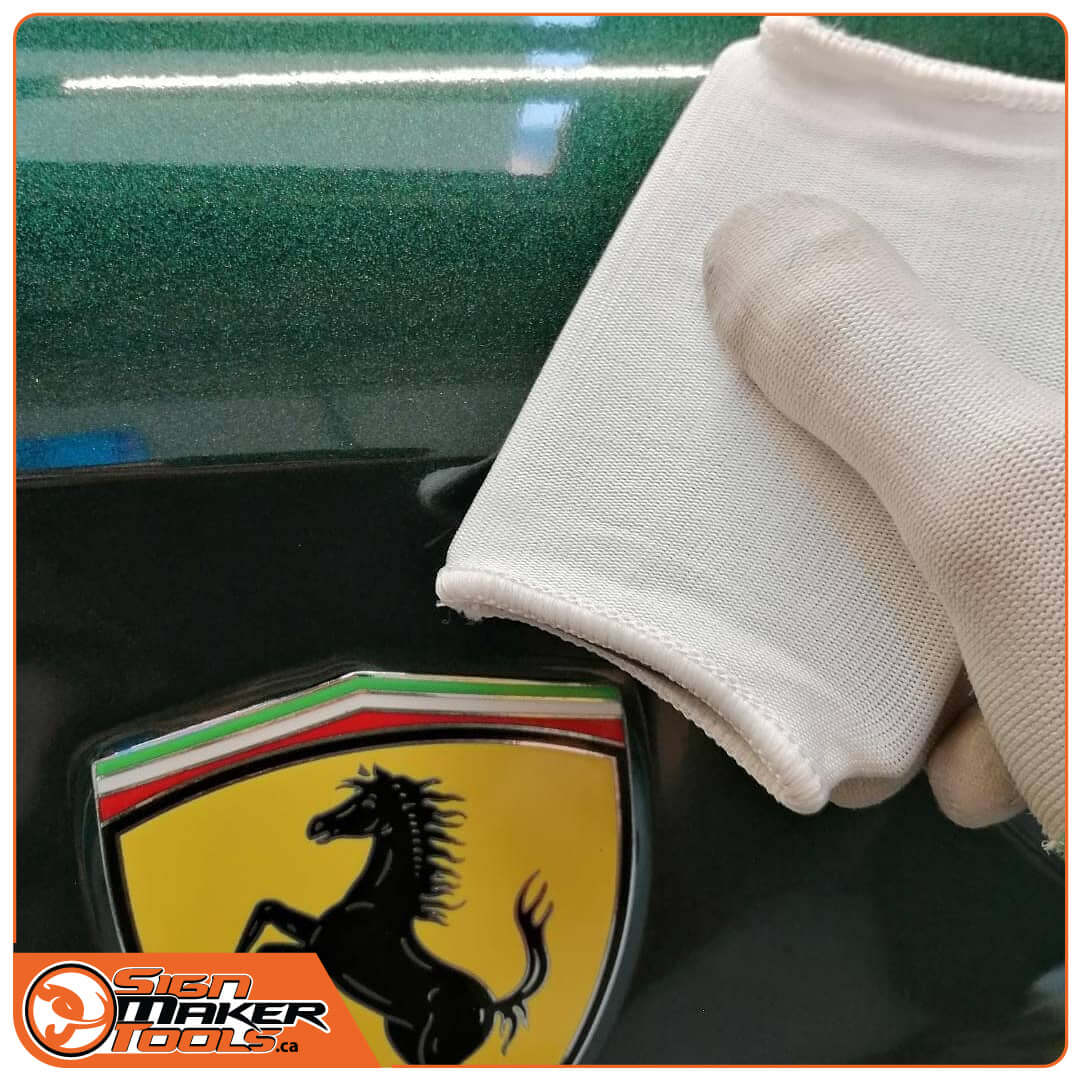 SGpocket PRO+ squeegee sleeve applied to a car emblem for smooth vinyl installation