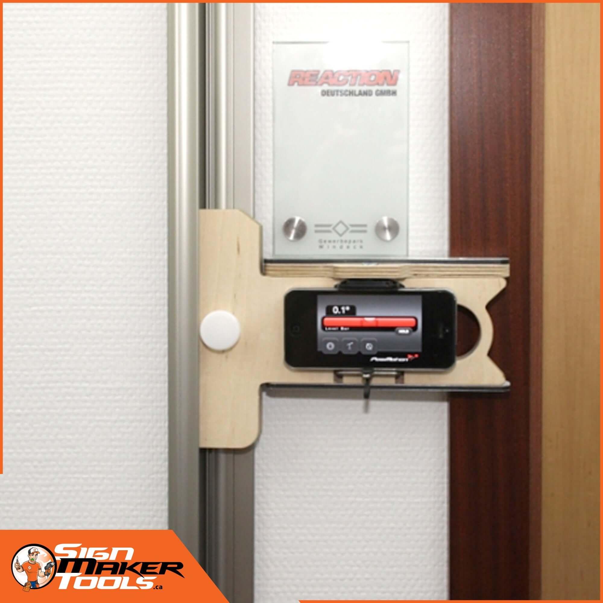 SignSetter mounting adapter in use for leveling a door sign with a smartphone angle tool