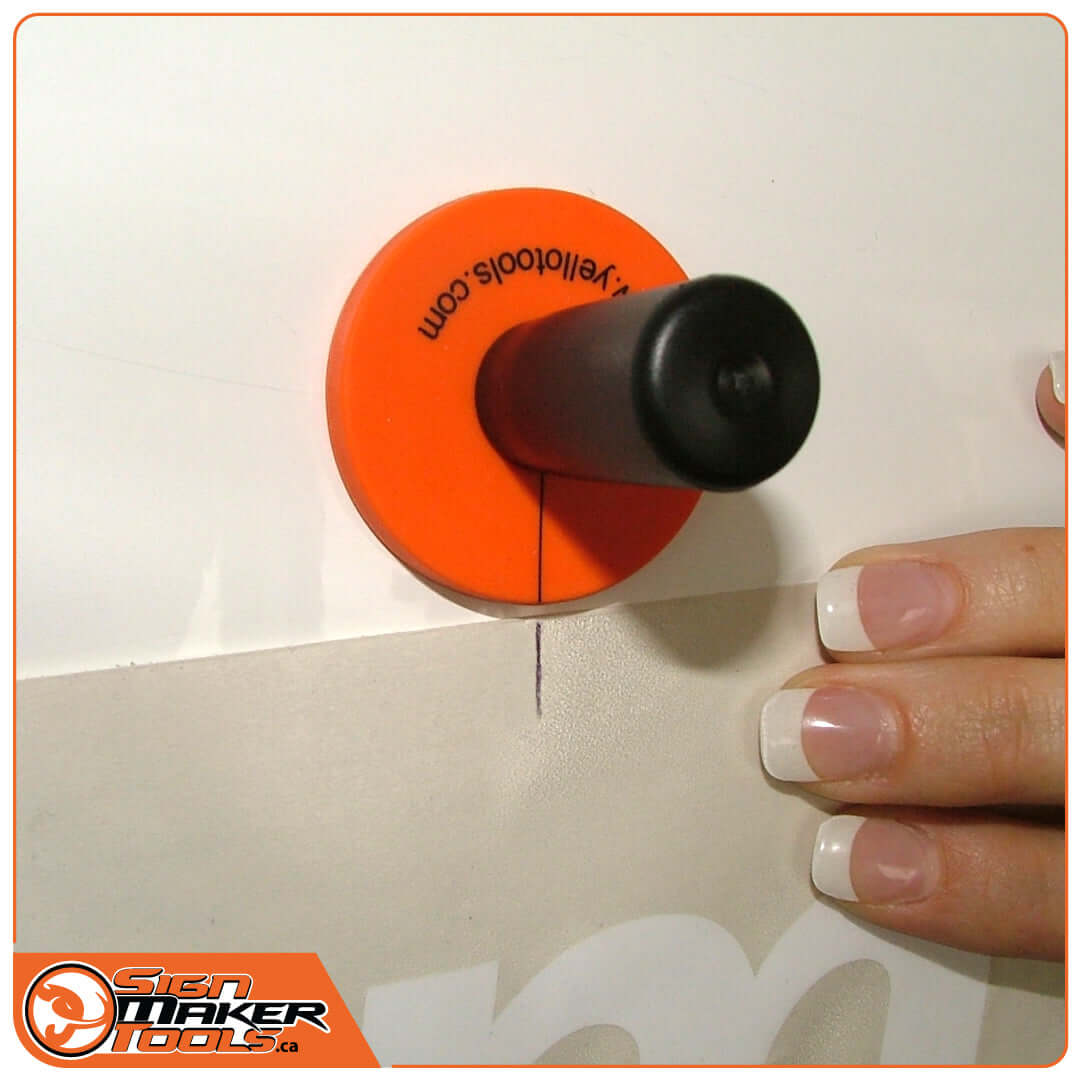 SpeedMag HD magnet holding signage in place on a smooth surface during application