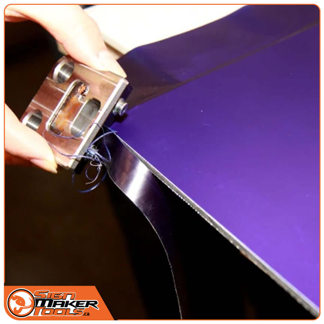 Using the AngelRacer tool to trim overlapping vinyl on a purple sign edge