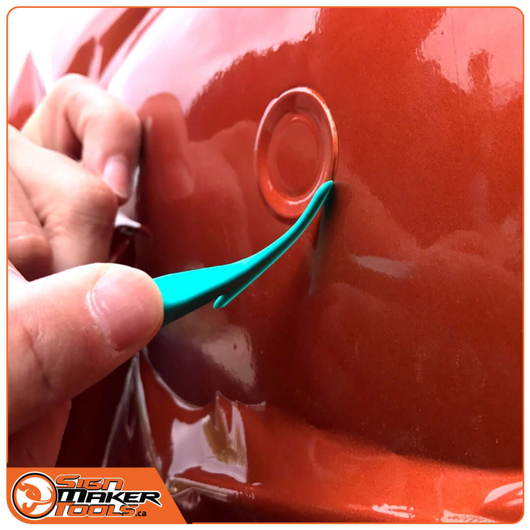 Using WrapStick Flex tool to tuck vinyl wrap around curved car detail