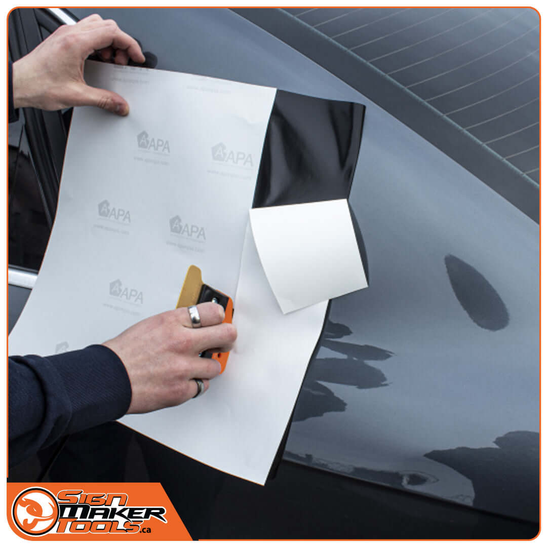 Applying vinyl wrap to car using YelloTwin hybrid squeegee knife