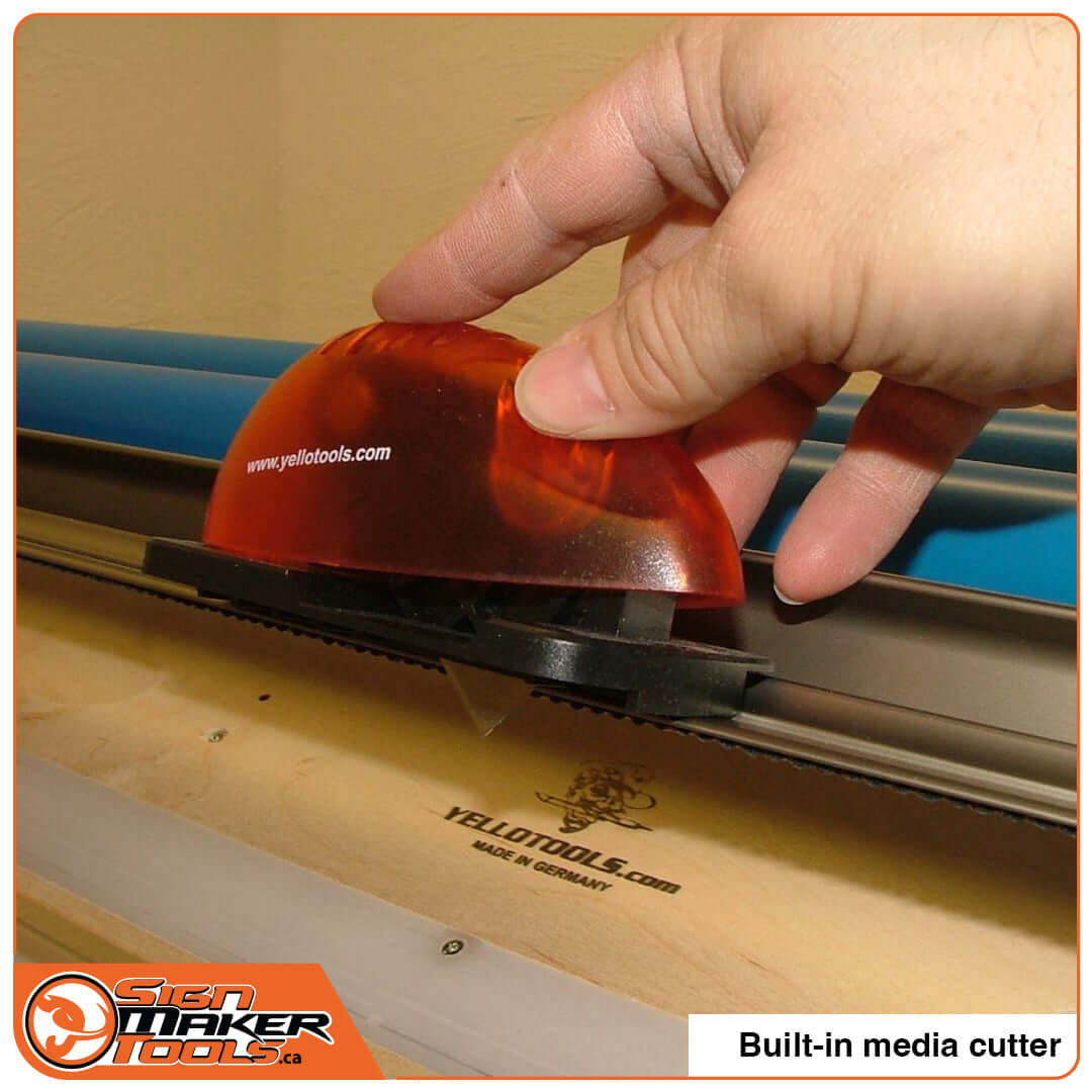 Hand operating TreeMAXX EasyReach PRO's built-in vinyl media cutter with orange handle