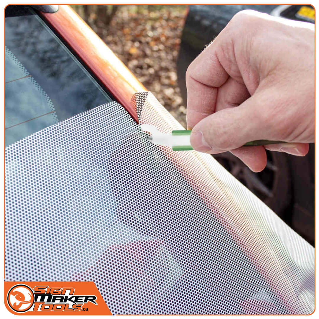 Cutting perforated window film on a car with the WrapDefender safety knife