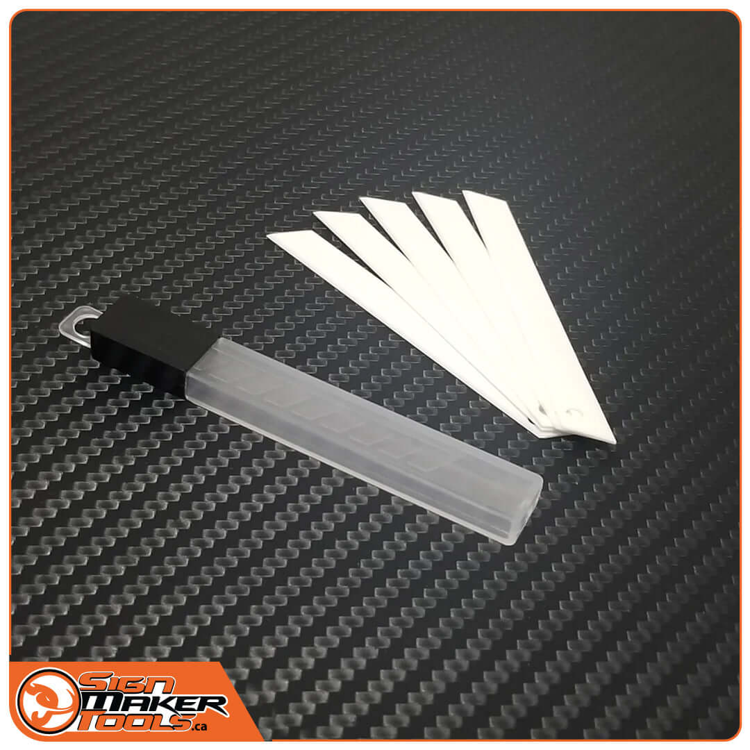 Five YelloCut Cera ceramic replacement blades with protective case on a carbon-textured surface