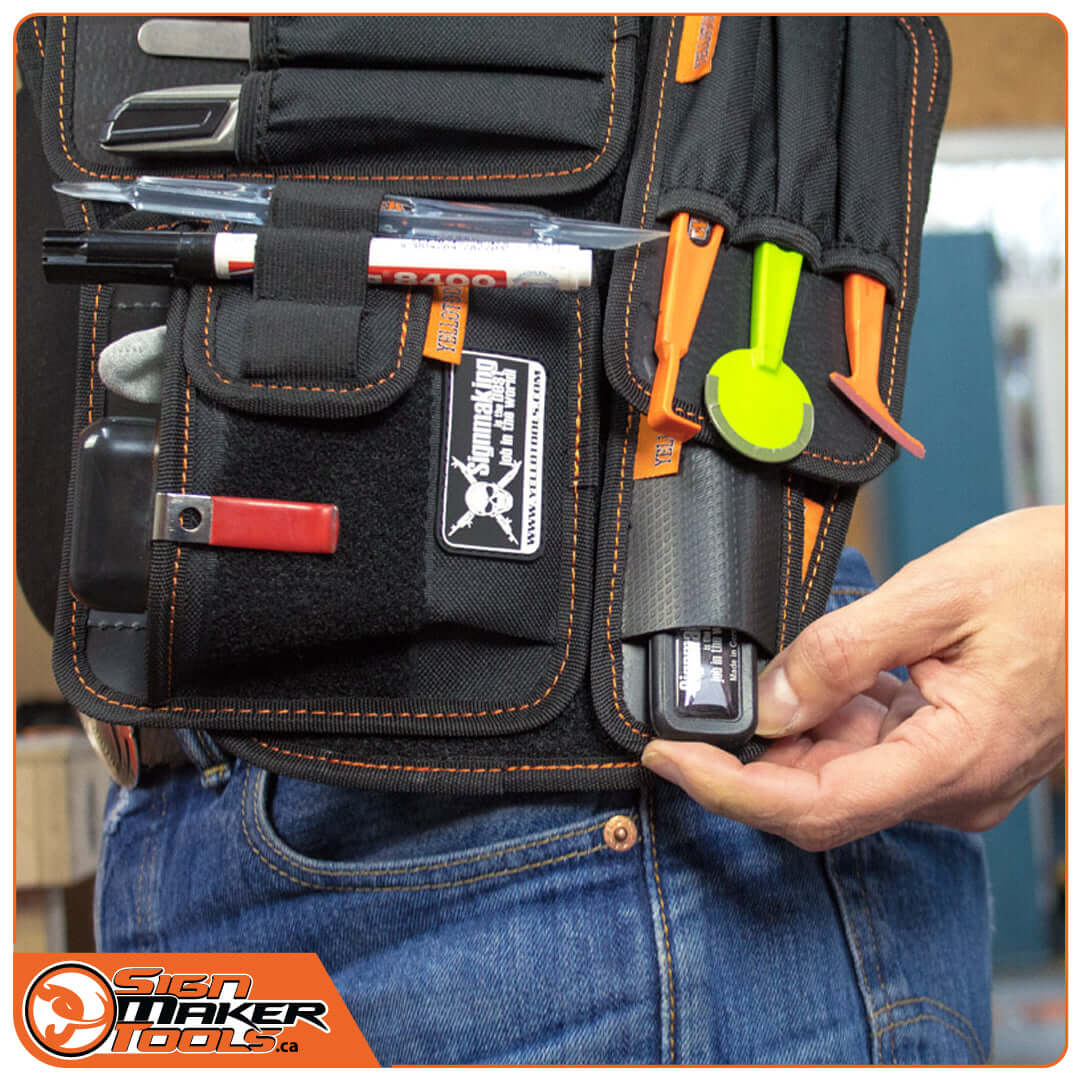 YelloGear tool belt in use, holding various sign making tools and accessories