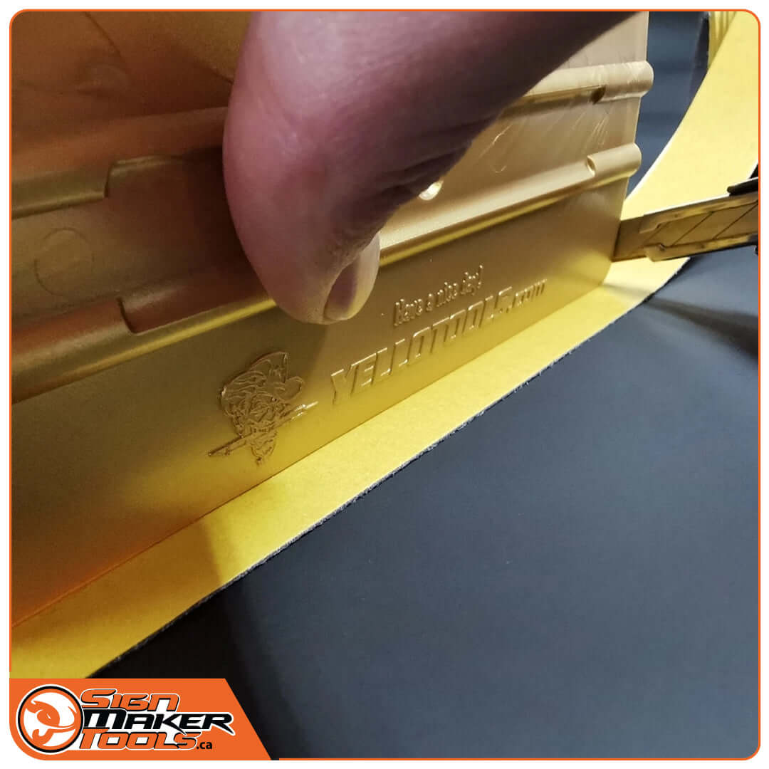 Peeling and applying MicroFine strip to a yellow Yellotools squeegee edge