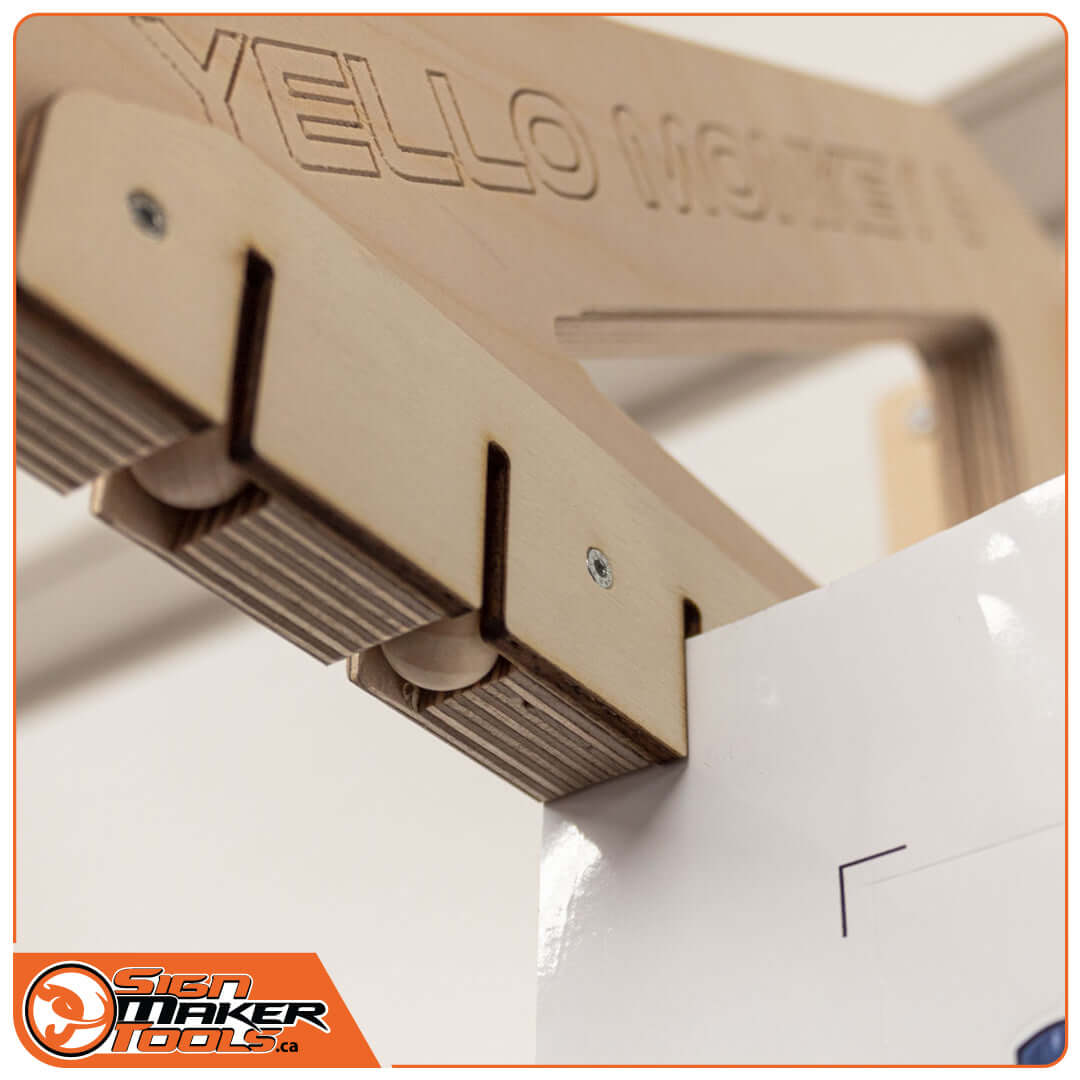 Close up of YelloMonkey 6 slot rack gripping a printed film for drying