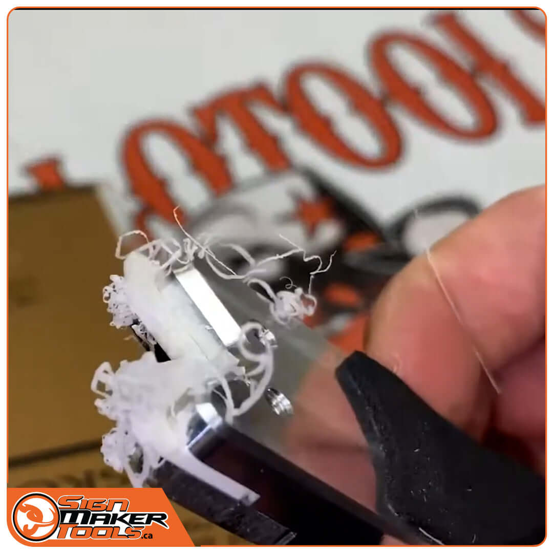 V-Trim tool removing burrs from an acrylic panel edge