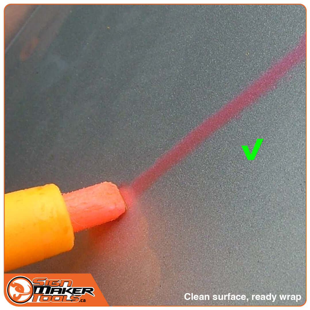 Testing pen on clean surface showing good adhesion with a green checkmark