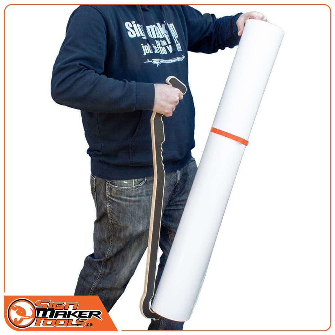 Person using TimStick lifting aid to carry a large vinyl roll