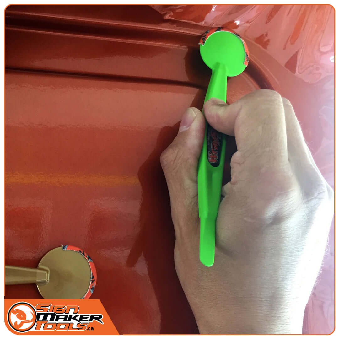 WrapStick Betty applying vinyl in a car door recess