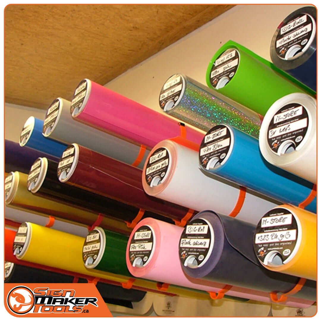 Assorted vinyl rolls labeled and organized with MediaLids lids on a rack system