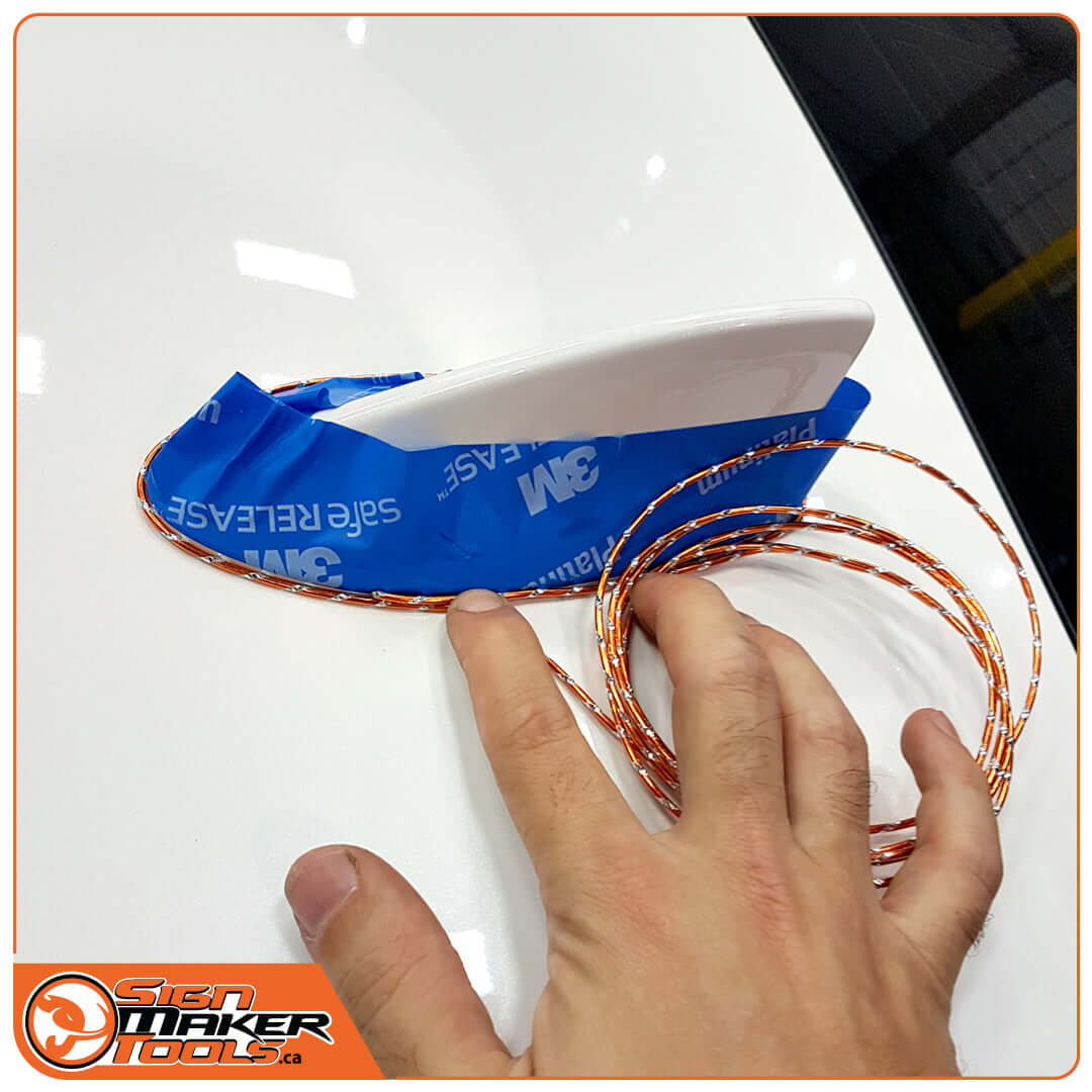 Using WrapBend-it wire to trace the contour of a vehicle fin wrapped in blue 3M tape