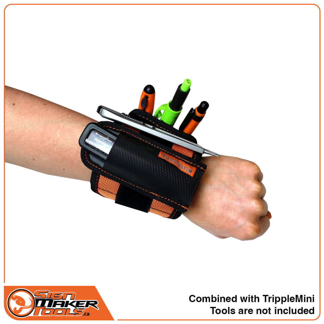 YelloStrap Pro wristband worn on arm with TrippleMini pouch, holding multiple tools